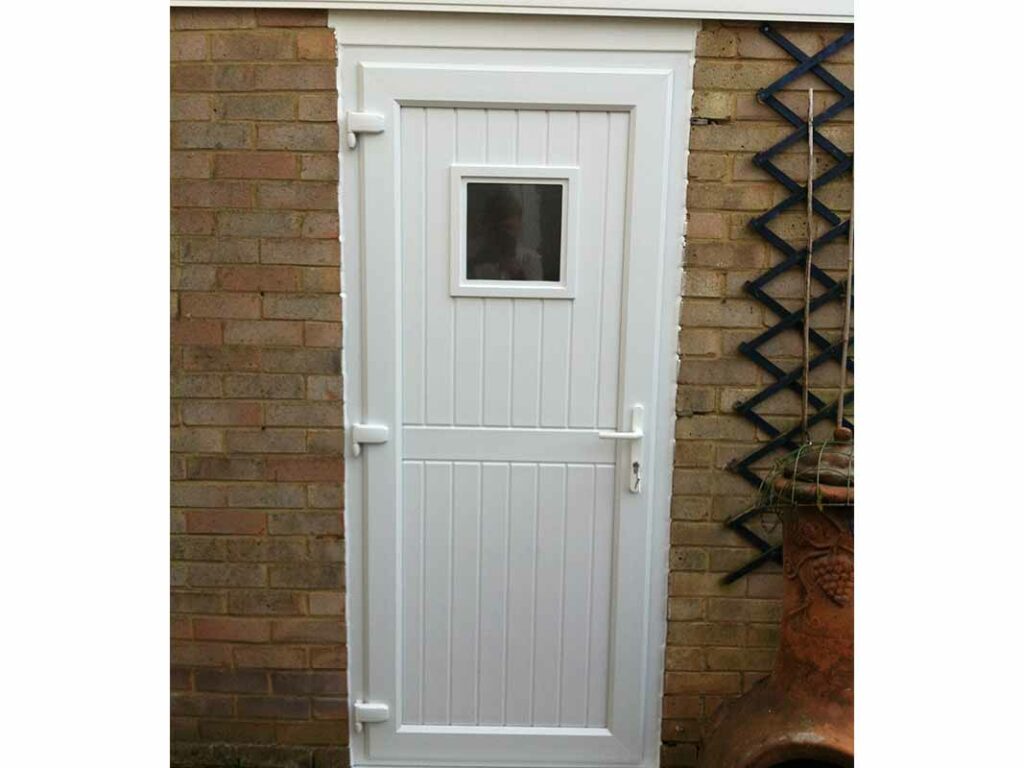 Traditional white side-hinged garage door with a small window