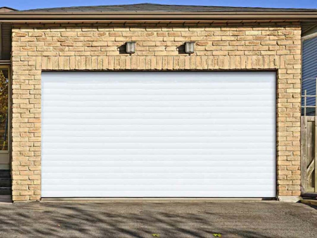 Modern anthracite grey sectional garage door on a brick home